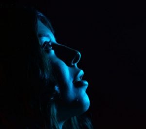 Image of female shot in blue light.